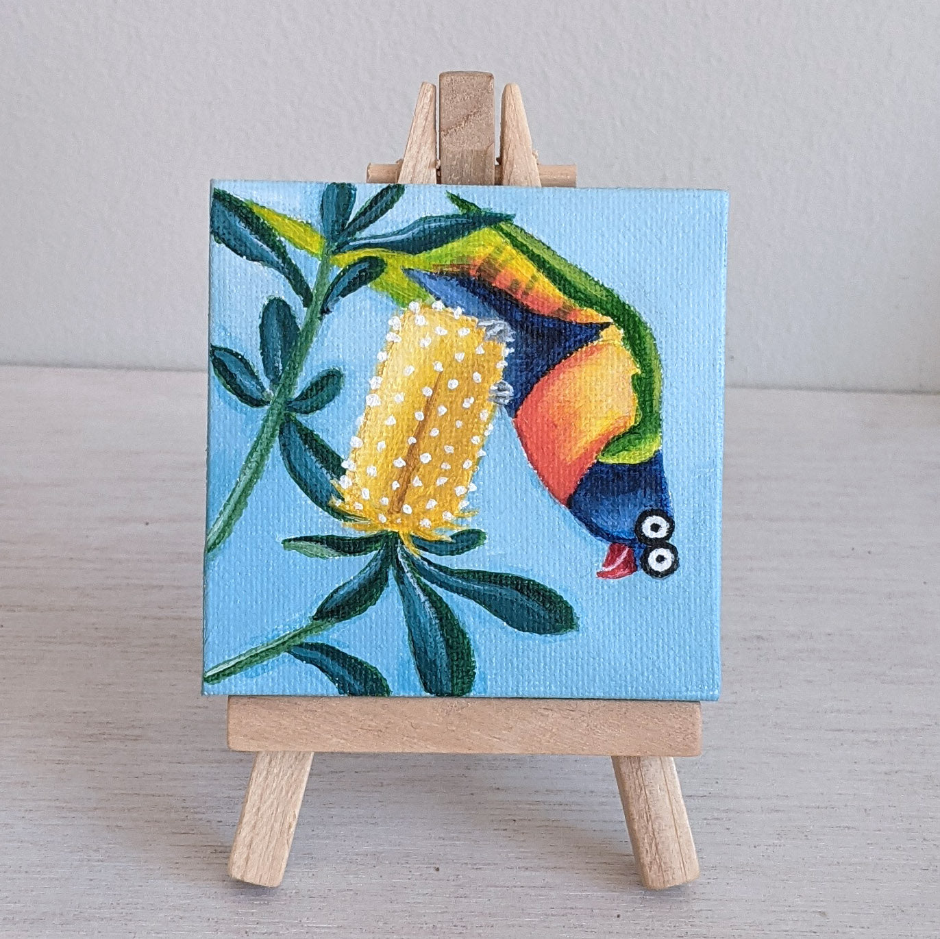 Rainbow lorikeet miniature acrylic painting, with wooden stand. Silly painting.